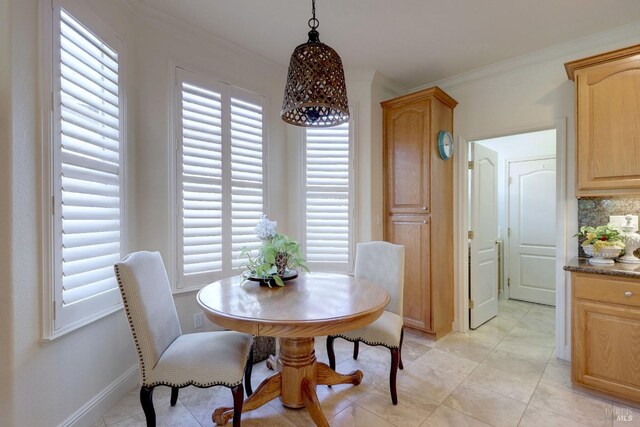 dining room with ornamental molding and a healthy amount of sunlight