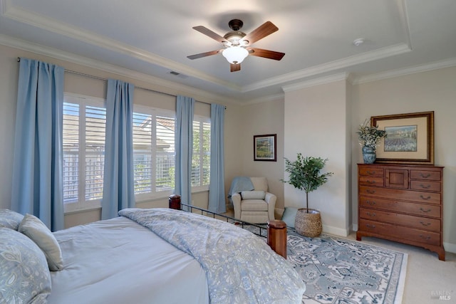 carpeted bedroom featuring crown molding, a raised ceiling, and ceiling fan