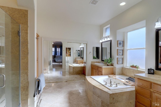 bathroom with a stall shower, visible vents, a garden tub, tile patterned flooring, and vanity