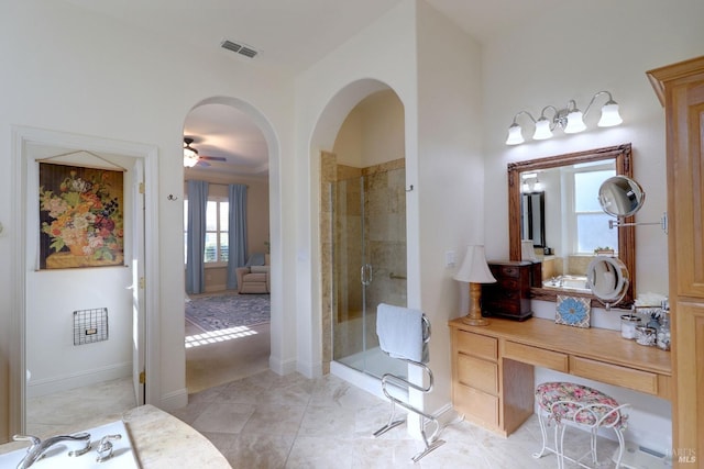 bathroom with vanity, ceiling fan, a shower with shower door, and tile patterned flooring