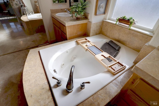 bathroom with vanity and a relaxing tiled tub