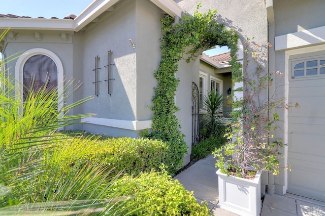 exterior space with a tiled roof and stucco siding