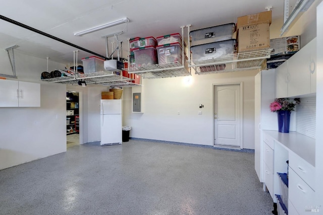 garage with a garage door opener, electric panel, and white refrigerator