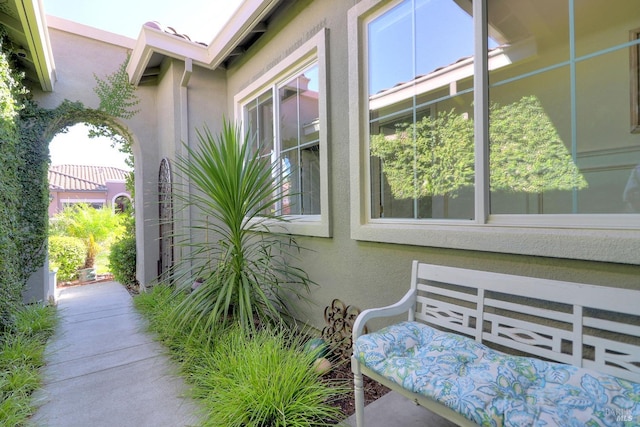 view of side of home with stucco siding