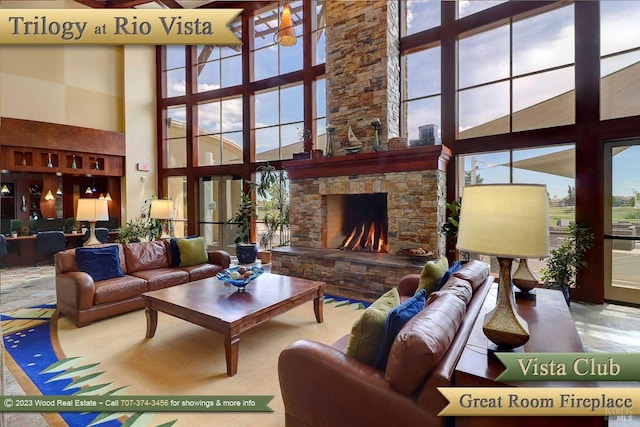 living room with a high ceiling and a fireplace