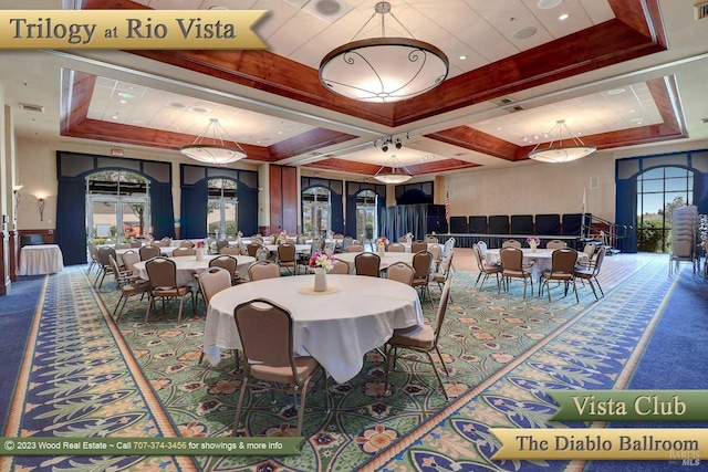 dining space with carpet floors and a raised ceiling