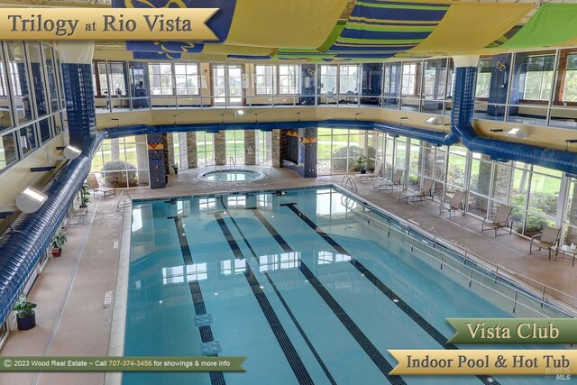 view of pool with an indoor hot tub