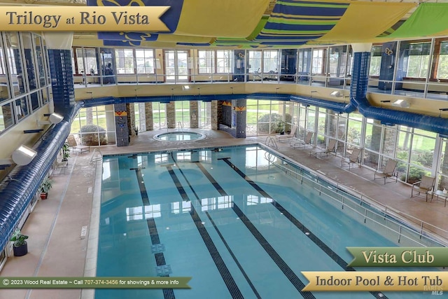 view of swimming pool featuring an indoor hot tub