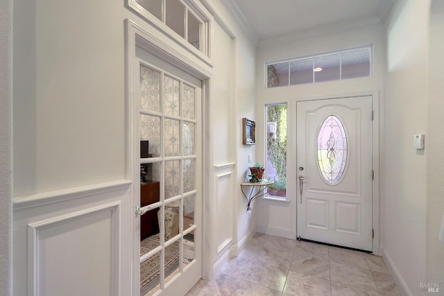 foyer featuring ornamental molding