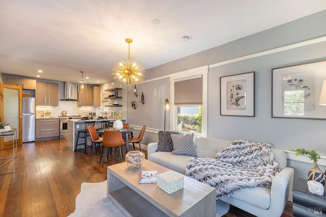 living room featuring a notable chandelier and dark hardwood / wood-style flooring