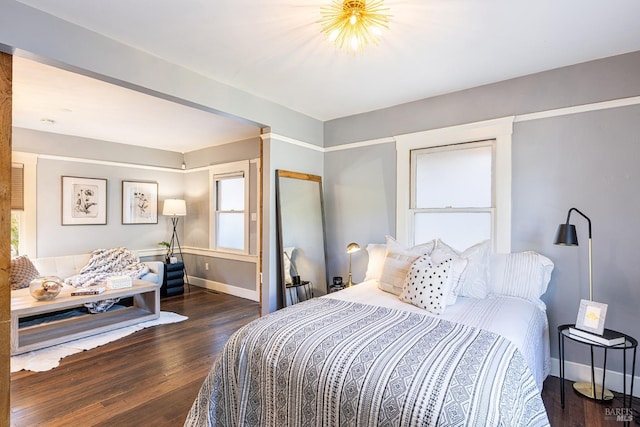 bedroom with dark hardwood / wood-style floors