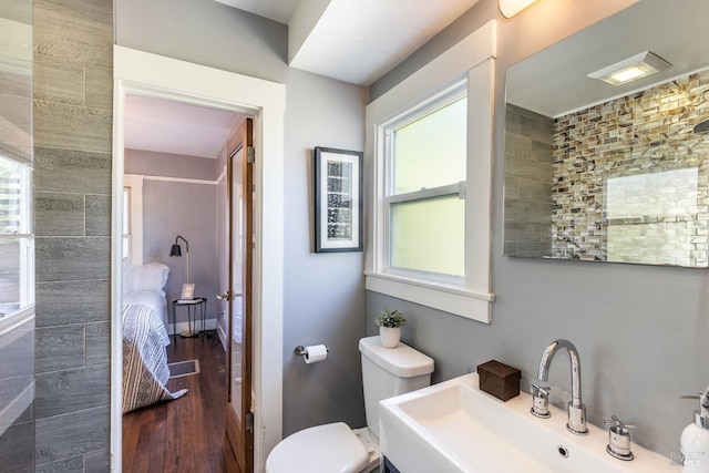 bathroom with hardwood / wood-style flooring, sink, and toilet