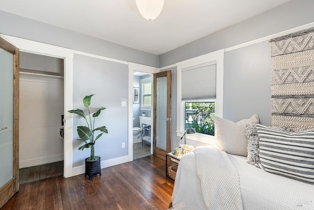 bedroom with a closet and dark wood-type flooring