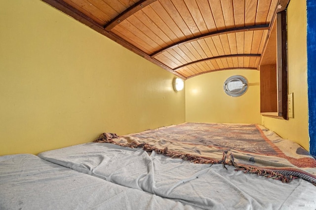 bedroom with lofted ceiling and wooden ceiling