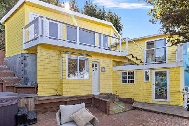 rear view of property with a balcony