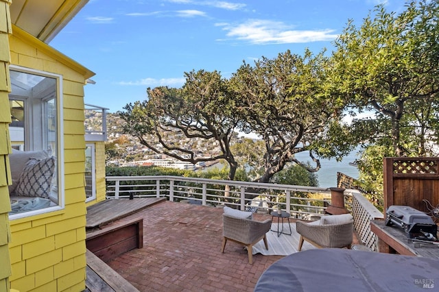 deck featuring area for grilling and a water view