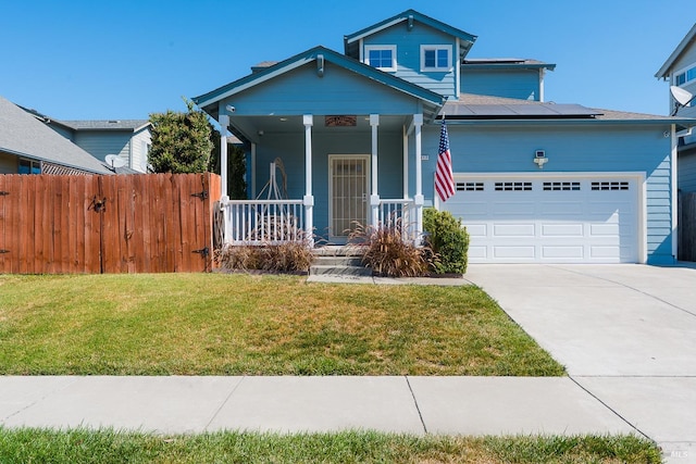 view of front of property with a front lawn, a porch, and a garage