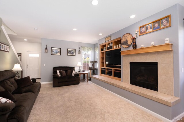 living room with light colored carpet and a fireplace