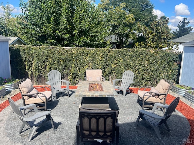 view of patio / terrace featuring an outdoor fire pit