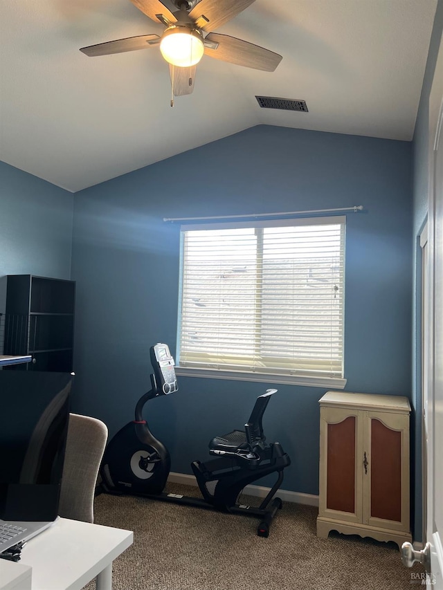 carpeted home office featuring lofted ceiling and ceiling fan