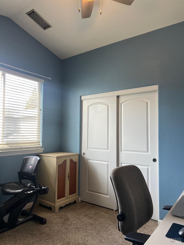 carpeted home office featuring ceiling fan and vaulted ceiling