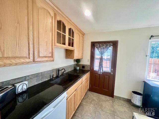 kitchen featuring sink, light brown cabinets, and dishwasher