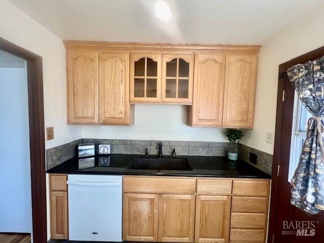 kitchen featuring light brown cabinetry, white dishwasher, and sink