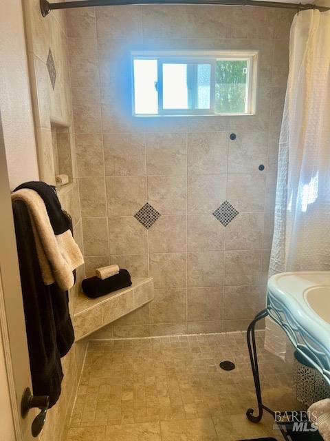 bathroom with a healthy amount of sunlight and a shower with curtain