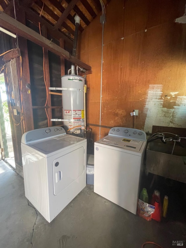 laundry area with washer and dryer and secured water heater