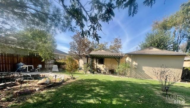 rear view of house with a patio area and a lawn