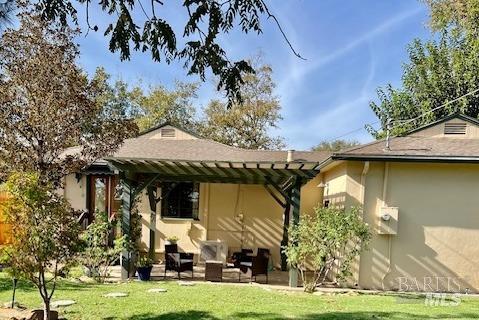 rear view of house with a yard