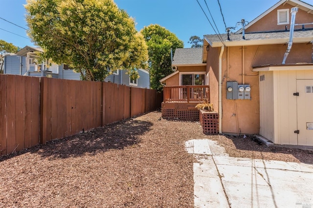 view of yard with a patio area and a wooden deck