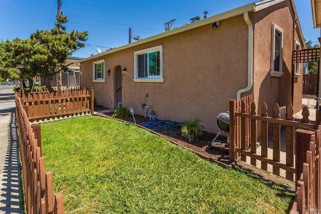 rear view of house with a yard