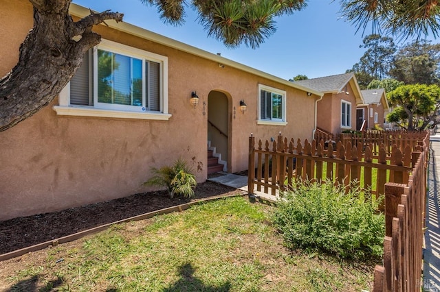 104 Alabama St, Vallejo, CA 94590 - view of front of house featuring fence, stucco siding, and entry steps
