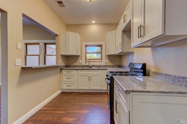 104 Alabama St, Vallejo, CA 94590 - kitchen featuring black range with gas stovetop, a sink, dark wood finished floors, white cabinetry, and baseboards