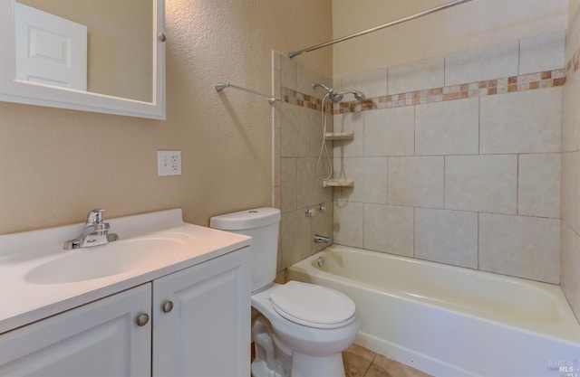 full bathroom featuring tiled shower / bath combo, tile patterned floors, vanity, and toilet