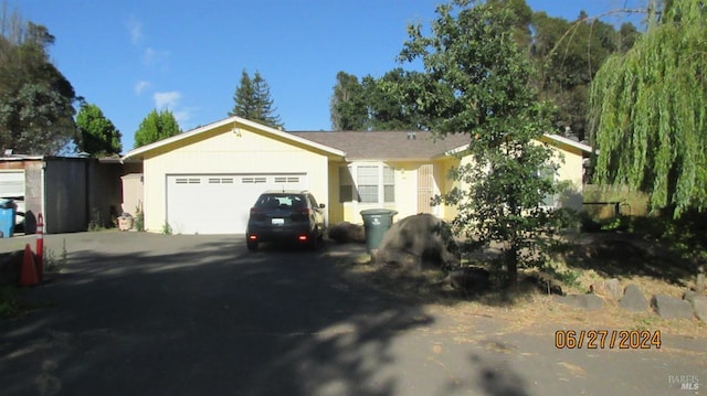 ranch-style home featuring a garage and driveway