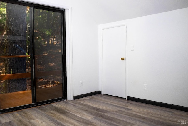 interior space with baseboards and wood finished floors