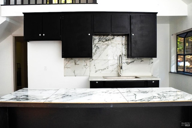 kitchen featuring backsplash and sink