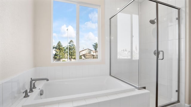 full bath with a garden tub and a shower stall