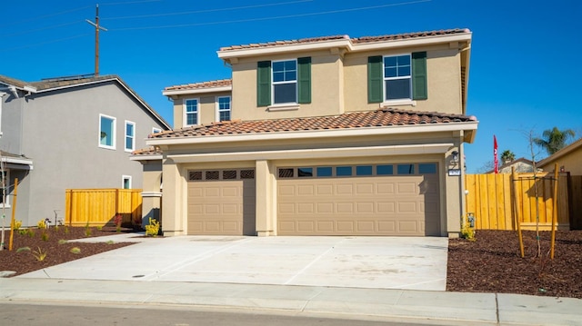 mediterranean / spanish home with stucco siding, driveway, a tile roof, fence, and an attached garage