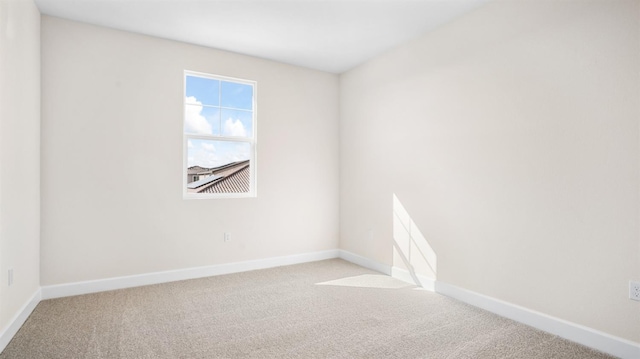 unfurnished room featuring baseboards and carpet floors