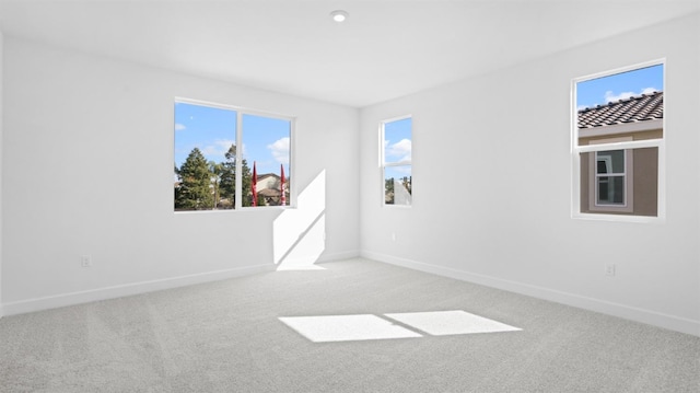 spare room featuring baseboards and carpet floors