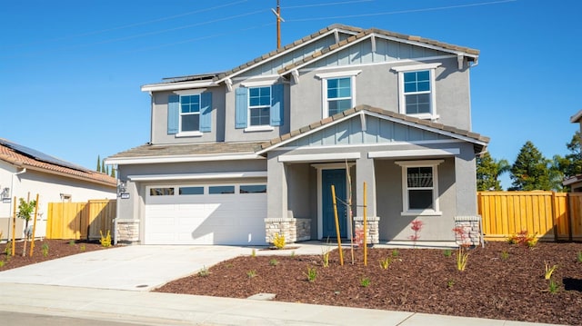 craftsman house featuring fence, an attached garage, concrete driveway, a tiled roof, and roof mounted solar panels