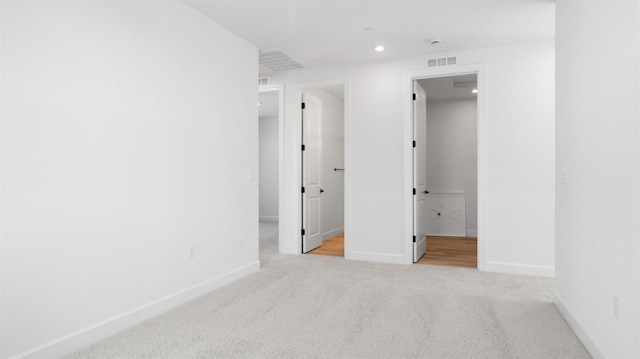 empty room featuring recessed lighting, carpet, visible vents, and baseboards