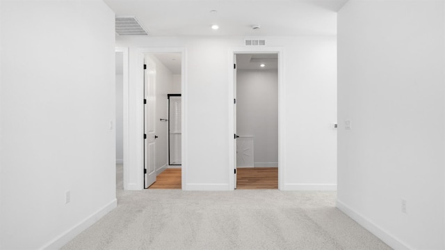 empty room with visible vents, carpet flooring, and baseboards