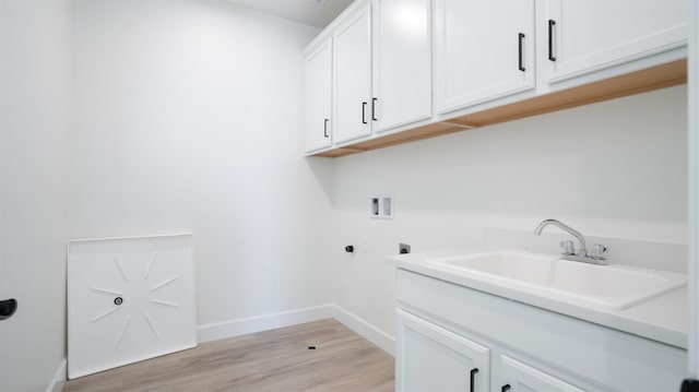 laundry room with hookup for an electric dryer, light wood-style flooring, cabinet space, a sink, and washer hookup