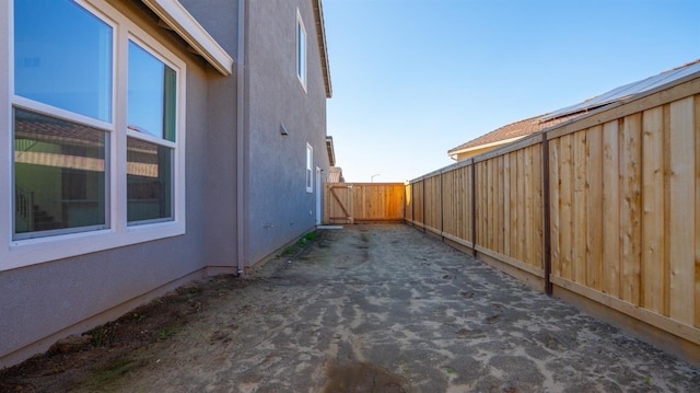 view of home's exterior with stucco siding and fence