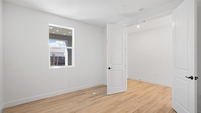 unfurnished room featuring light wood-style flooring and baseboards