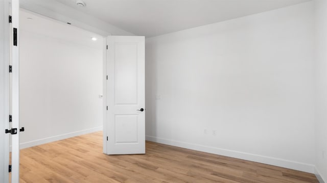 unfurnished bedroom featuring light wood-type flooring and baseboards